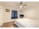 Bedroom with hardwood floors, a bed with a white and blue comforter, and natural light at 3003 Tamarind Dr, Edgewater, FL 32141