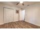 Bedroom with wood-look floors, ceiling fan, closet, and a bright, white color scheme at 3003 Tamarind Dr, Edgewater, FL 32141