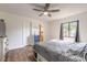 Bedroom with ceiling fan, wood-look floors, and a window providing natural light at 3003 Tamarind Dr, Edgewater, FL 32141