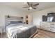 Bedroom with wood-look floors, ceiling fan, and a dresser with a mounted television at 3003 Tamarind Dr, Edgewater, FL 32141