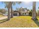 Charming single-story home with a well-maintained lawn and mature trees at 3003 Tamarind Dr, Edgewater, FL 32141