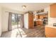 Sunlit kitchen with wood cabinets, stainless steel appliances, and access to the backyard through sliding glass doors at 3003 Tamarind Dr, Edgewater, FL 32141