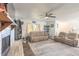 Bright living room features a brick fireplace, neutral walls, comfortable seating, and a ceiling fan at 3003 Tamarind Dr, Edgewater, FL 32141