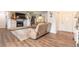 Spacious living room with hardwood floors, brick fireplace, and comfortable seating, creating an inviting atmosphere at 3003 Tamarind Dr, Edgewater, FL 32141