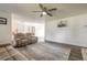 Expansive living room with hardwood flooring, neutral paint, ceiling fan, and comfortable seating arrangement at 3003 Tamarind Dr, Edgewater, FL 32141