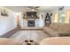 Cozy living room with a brick fireplace, ceiling fan, comfortable seating, and a neutral color palette at 3003 Tamarind Dr, Edgewater, FL 32141