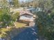 Aerial view of a house showing the backyard with a wooden fence and a spacious driveway at 3003 Tamarind Dr, Edgewater, FL 32141