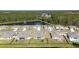 Aerial view of the neighborhood featuring a pond and meticulously planned homesites surrounded by lush greenery at 301 Sunset Point Dr, Ormond Beach, FL 32174