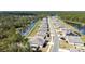 Community aerial showcasing the layout with adjacent ponds, sidewalks, and forest views at 301 Sunset Point Dr, Ormond Beach, FL 32174
