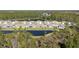 Aerial view of neighborhood with pond view, lush landscaping, and harmonious blend of nature and community at 301 Sunset Point Dr, Ormond Beach, FL 32174