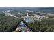 A beautiful aerial view of a residential community surrounding a picturesque pond at 301 Sunset Point Dr, Ormond Beach, FL 32174