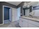 Bathroom featuring double sinks with granite countertops, tiled floors, and contemporary light fixtures at 301 Sunset Point Dr, Ormond Beach, FL 32174