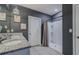 Modern bathroom featuring a double sink vanity, granite countertop, and a walk-in shower at 301 Sunset Point Dr, Ormond Beach, FL 32174