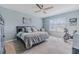 Light and airy bedroom featuring a ceiling fan, plush carpet, and a large window with natural light at 301 Sunset Point Dr, Ormond Beach, FL 32174