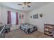 Cozy bedroom with carpet flooring, natural light, and a decorated wall with themed artwork at 301 Sunset Point Dr, Ormond Beach, FL 32174