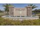 Elegant Pineland community entrance sign with stone accents and a water fountain feature at 301 Sunset Point Dr, Ormond Beach, FL 32174