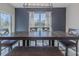 Dining room with a dark wood table, bench seating, and natural light from the large windows at 301 Sunset Point Dr, Ormond Beach, FL 32174