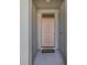 Front door entrance with neutral colored door, door mat, and porch overhang at 301 Sunset Point Dr, Ormond Beach, FL 32174