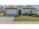 Charming single-story home features a well-manicured lawn, inviting entrance, and two-car garage at 301 Sunset Point Dr, Ormond Beach, FL 32174
