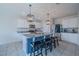 Stylish kitchen with a center island, granite countertops, white cabinets, and stainless steel appliances at 301 Sunset Point Dr, Ormond Beach, FL 32174