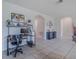 Open living area with a workstation, neutral walls, and tiled floors leading to other rooms at 301 Sunset Point Dr, Ormond Beach, FL 32174