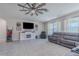 Open living room featuring tile flooring, ceiling fan, and large sectional couch at 301 Sunset Point Dr, Ormond Beach, FL 32174