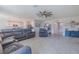 Open living room with tile floors, large couch, and open view to the kitchen at 301 Sunset Point Dr, Ormond Beach, FL 32174