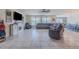 Spacious living room featuring tile flooring, a large sectional couch, and modern ceiling fan at 301 Sunset Point Dr, Ormond Beach, FL 32174