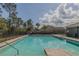 Refreshing community pool with lounge chairs, palm trees, and clear blue water, perfect for relaxation and recreation at 301 Sunset Point Dr, Ormond Beach, FL 32174