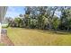 Lush back yard with mature trees and natural foliage provides a private outdoor space at 3029 Adrian Dr, Ormond Beach, FL 32174