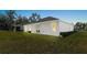 Lush backyard with green lawn, a covered patio, and views of neighboring houses at 3029 Adrian Dr, Ormond Beach, FL 32174
