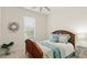 Bright bedroom with a wooden bed, blue bedding, and a window at 3029 Adrian Dr, Ormond Beach, FL 32174