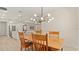 Open concept dining room with wooden table, modern lighting, and hardwood floors at 3029 Adrian Dr, Ormond Beach, FL 32174