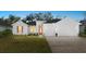 Charming home featuring a well-manicured lawn, neutral palette, and a two-car garage at 3029 Adrian Dr, Ormond Beach, FL 32174
