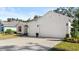 Expansive three car garage exhibiting doors, stone accents and manicured landscaping at 3029 Adrian Dr, Ormond Beach, FL 32174