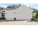 Spacious 2-car garage with white doors and stone veneer accents at 3029 Adrian Dr, Ormond Beach, FL 32174