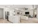 Open concept kitchen featuring white cabinets, stainless steel appliances, and an island with seating at 3029 Adrian Dr, Ormond Beach, FL 32174
