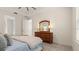 Neutral bedroom boasts wood flooring, dresser, and an open doorway to an adjoining room at 3029 Adrian Dr, Ormond Beach, FL 32174
