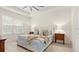 Bright main bedroom features tray ceilings, neutral walls, with wood flooring, and well-lit bedside tables at 3029 Adrian Dr, Ormond Beach, FL 32174