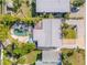 Backyard with a kidney-shaped pool surrounded by lounge chairs and tropical landscaping, perfect for outdoor relaxation at 308 Normandy Ave, New Smyrna Beach, FL 32169