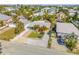 Bright, single-story home featuring a colorful exterior, well-manicured lawn, driveway, and tropical landscaping at 308 Normandy Ave, New Smyrna Beach, FL 32169