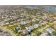 Expansive aerial view showcasing a charming residential neighborhood with waterfront access and lush green landscaping at 308 Normandy Ave, New Smyrna Beach, FL 32169
