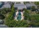 Aerial view of a private backyard showcasing a swimming pool, and a beautiful landscaped outdoor living and entertaining space at 308 Normandy Ave, New Smyrna Beach, FL 32169