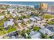 Overview of a residential neighborhood near the beach featuring colorful homes, lush landscaping, and ocean views at 308 Normandy Ave, New Smyrna Beach, FL 32169