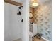 Modern bathroom with white subway tile shower and unique patterned wallpaper at 308 Normandy Ave, New Smyrna Beach, FL 32169