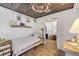 Charming bedroom featuring wood ceiling, white brick walls, and stylish decor at 308 Normandy Ave, New Smyrna Beach, FL 32169
