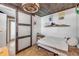 Bedroom features wood ceilings, unique lighting, and sliding closet door at 308 Normandy Ave, New Smyrna Beach, FL 32169