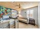 This colorful bedroom has mural art, a ceiling fan, and shuttered windows at 308 Normandy Ave, New Smyrna Beach, FL 32169