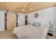 This bedroom features wood ceilings, blinds and a sliding closet door at 308 Normandy Ave, New Smyrna Beach, FL 32169