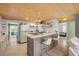 Bright kitchen with a breakfast bar, retro refrigerator, and plenty of counter space, perfect for cooking and entertaining at 308 Normandy Ave, New Smyrna Beach, FL 32169